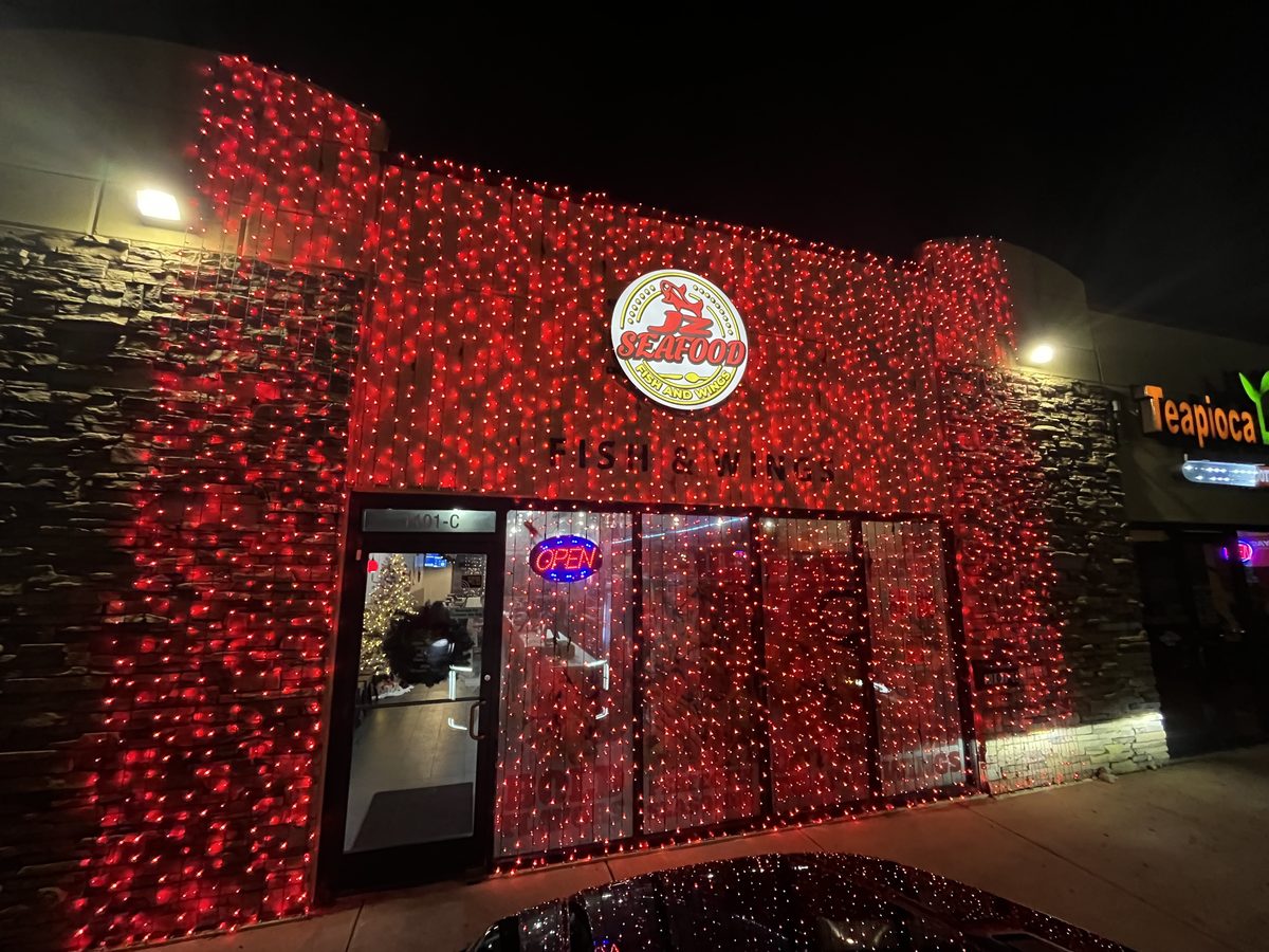 Restaurant storefront covered in red curtain lights for the holidays